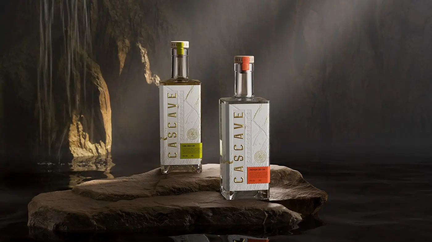 A bottle of Cascave Gin with intricate deboss detailing that resembles the rocky surfaces of Welsh caves, fluted and pressed foils glinting like mineral deposits, set against a palette inspired by the natural colors of the Brecon Beacons.