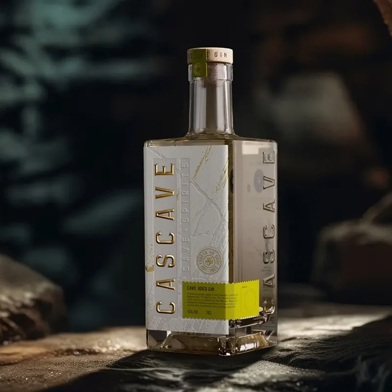 A bottle of Cascave Gin with intricate deboss detailing that resembles the rocky surfaces of Welsh caves, fluted and pressed foils glinting like mineral deposits, set against a palette inspired by the natural colors of the Brecon Beacons.