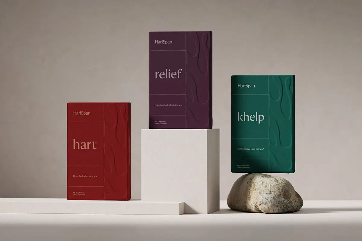 Minimalistic and elegant packaging of HartSpan, by FORNER STUDIO, featuring a soothing color palette with shades of blue and green, representing longevity and natural healing. The design incorporates an organic kelp silhouette, emphasizing the brand's use of natural seaweed ingredients to combat acid reflux, especially during pregnancy.