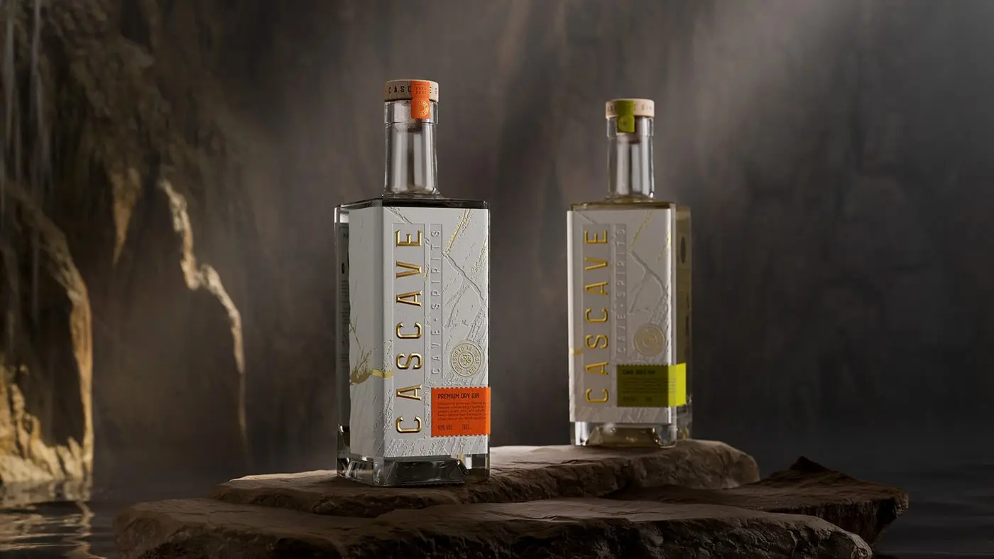 A bottle of Cascave Gin with intricate deboss detailing that resembles the rocky surfaces of Welsh caves, fluted and pressed foils glinting like mineral deposits, set against a palette inspired by the natural colors of the Brecon Beacons.