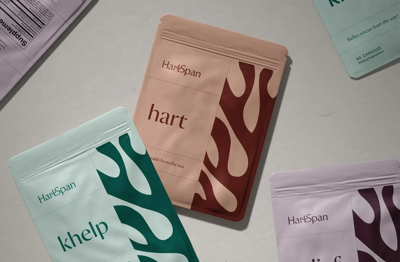 Minimalistic and elegant packaging of HartSpan, by FORNER STUDIO, featuring a soothing color palette with shades of blue and green, representing longevity and natural healing. The design incorporates an organic kelp silhouette, emphasizing the brand's use of natural seaweed ingredients to combat acid reflux, especially during pregnancy.